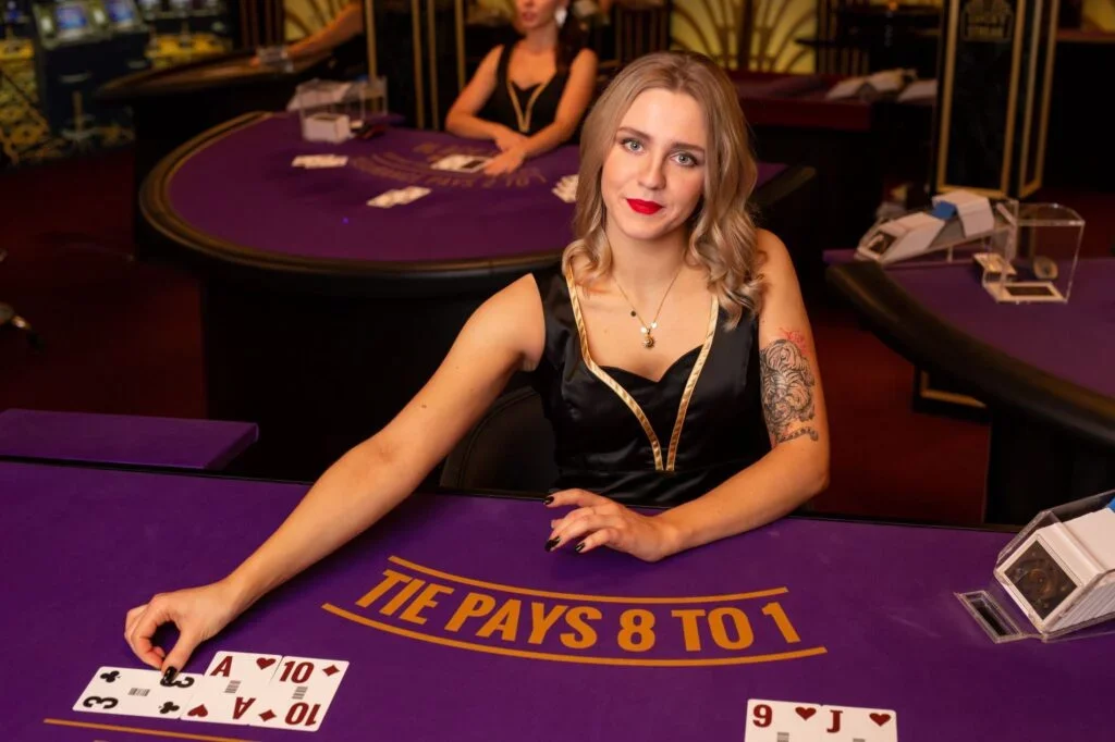 Live dealer baccarat casino table with real dealer and cards